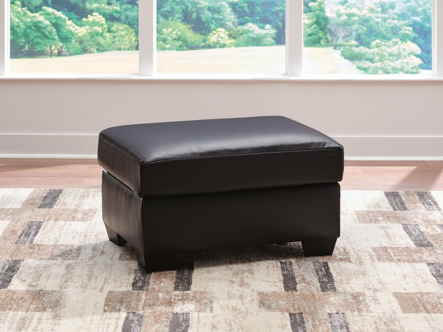 Glennbre Midnight Faux Leather Ottoman from Ella Furniture