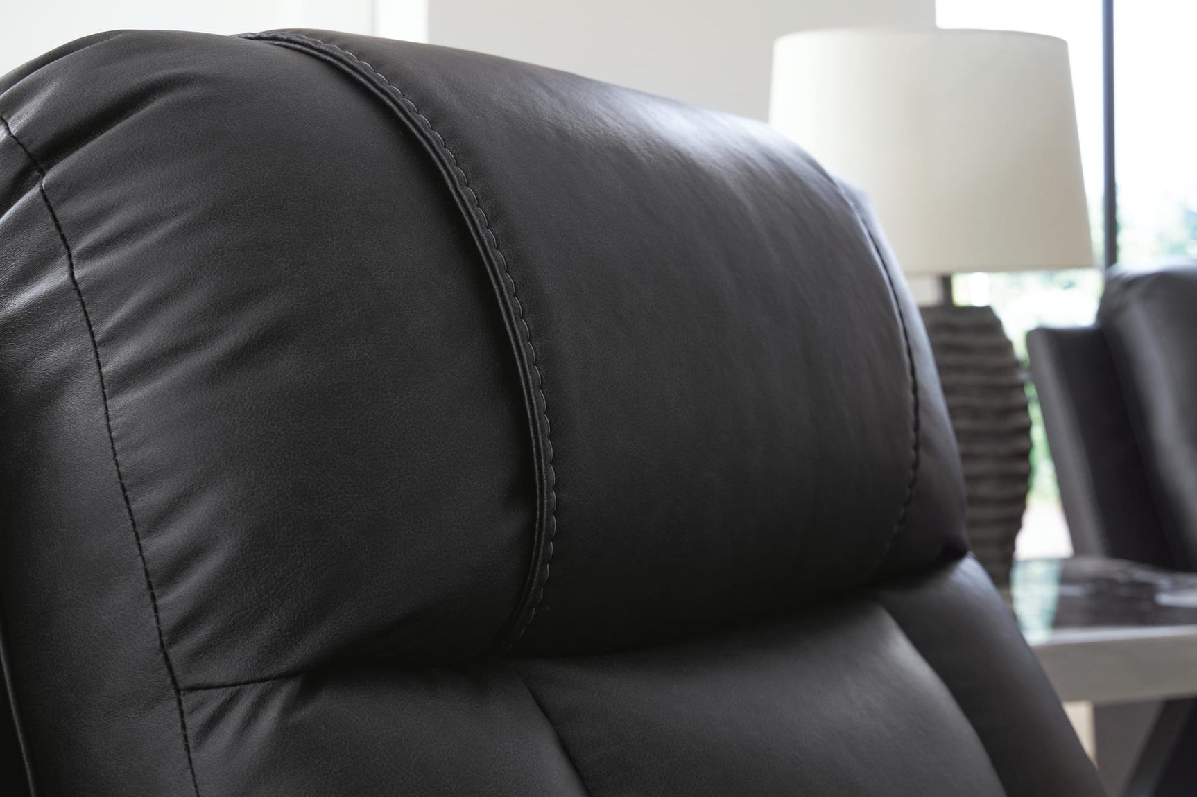 Mackmenville Carbon Faux Leather Recliner from Ella Furniture