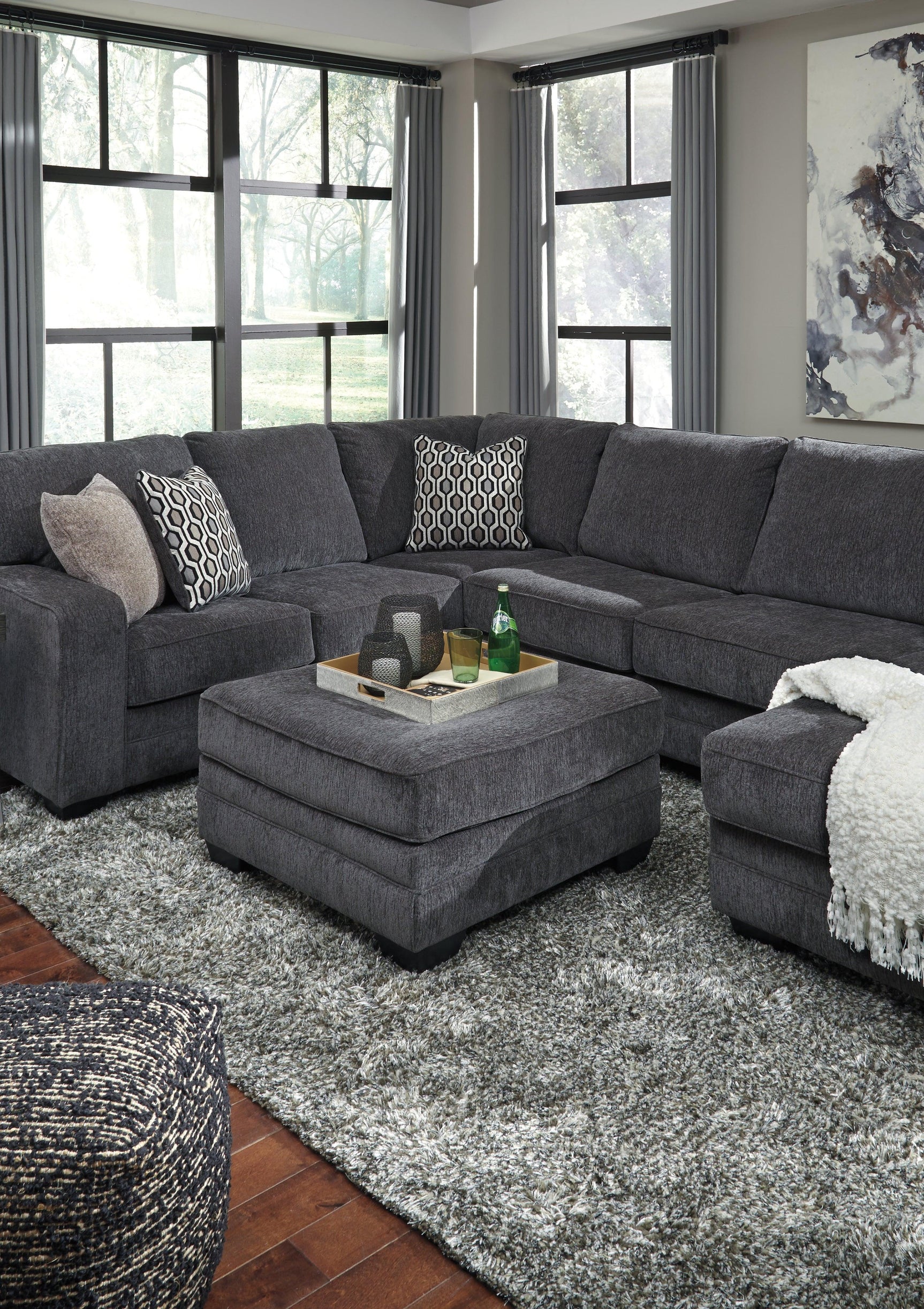 Hidden storage ottoman with faux wood feet, side view