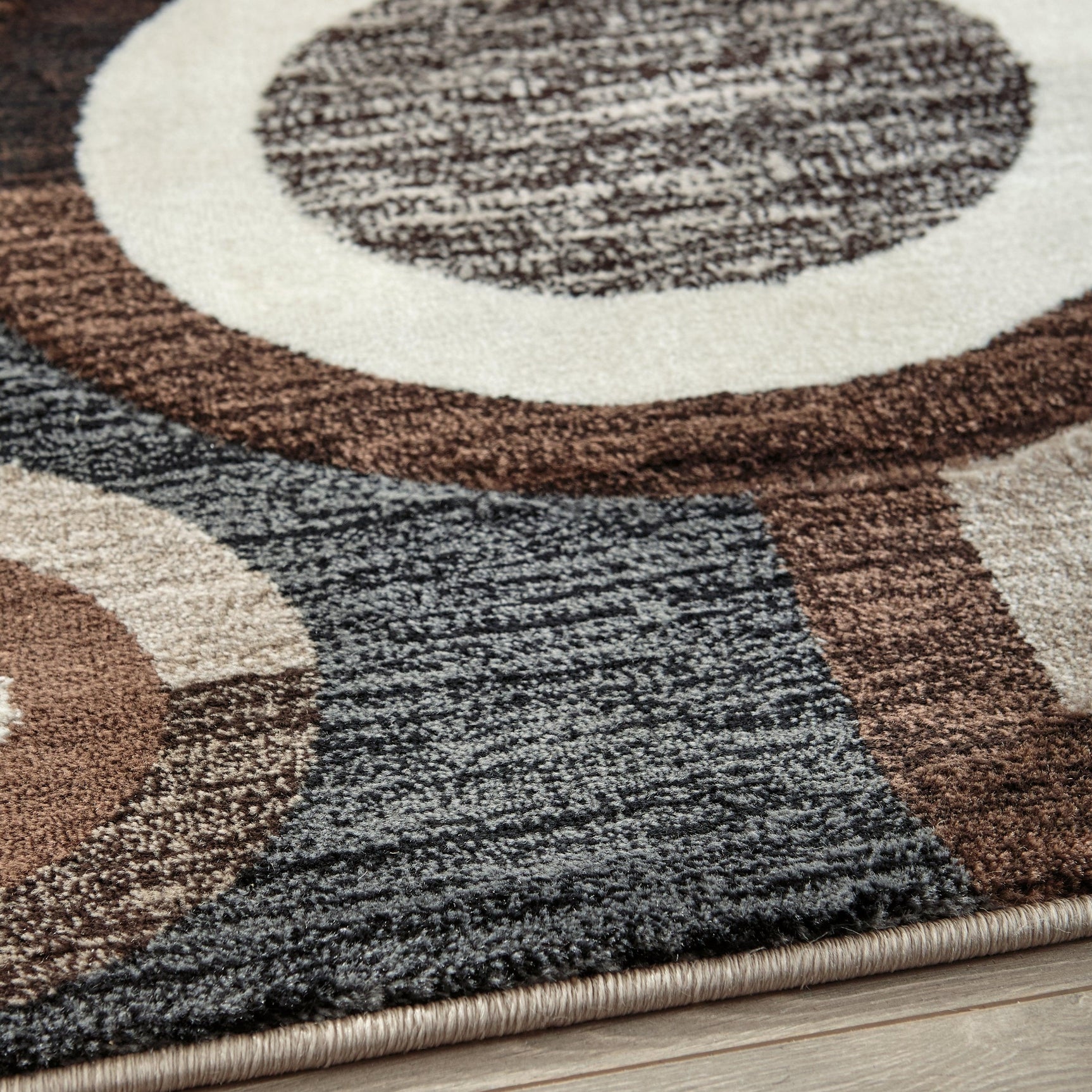 Close-up of Guintte Multi geometric design and pile texture on area rug