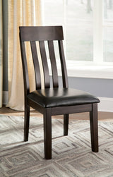 Haddigan dining chair angled view showing dark brown wood frame and tufted seat