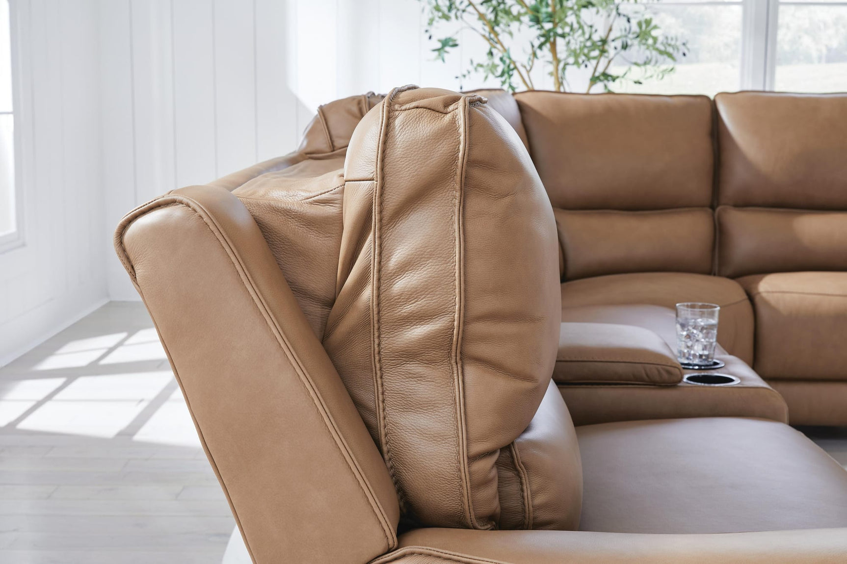 DeepWakes Caramel Leather 7-Piece Reclining Sectional with Chaise and Storage Consoles from Ella Furniture