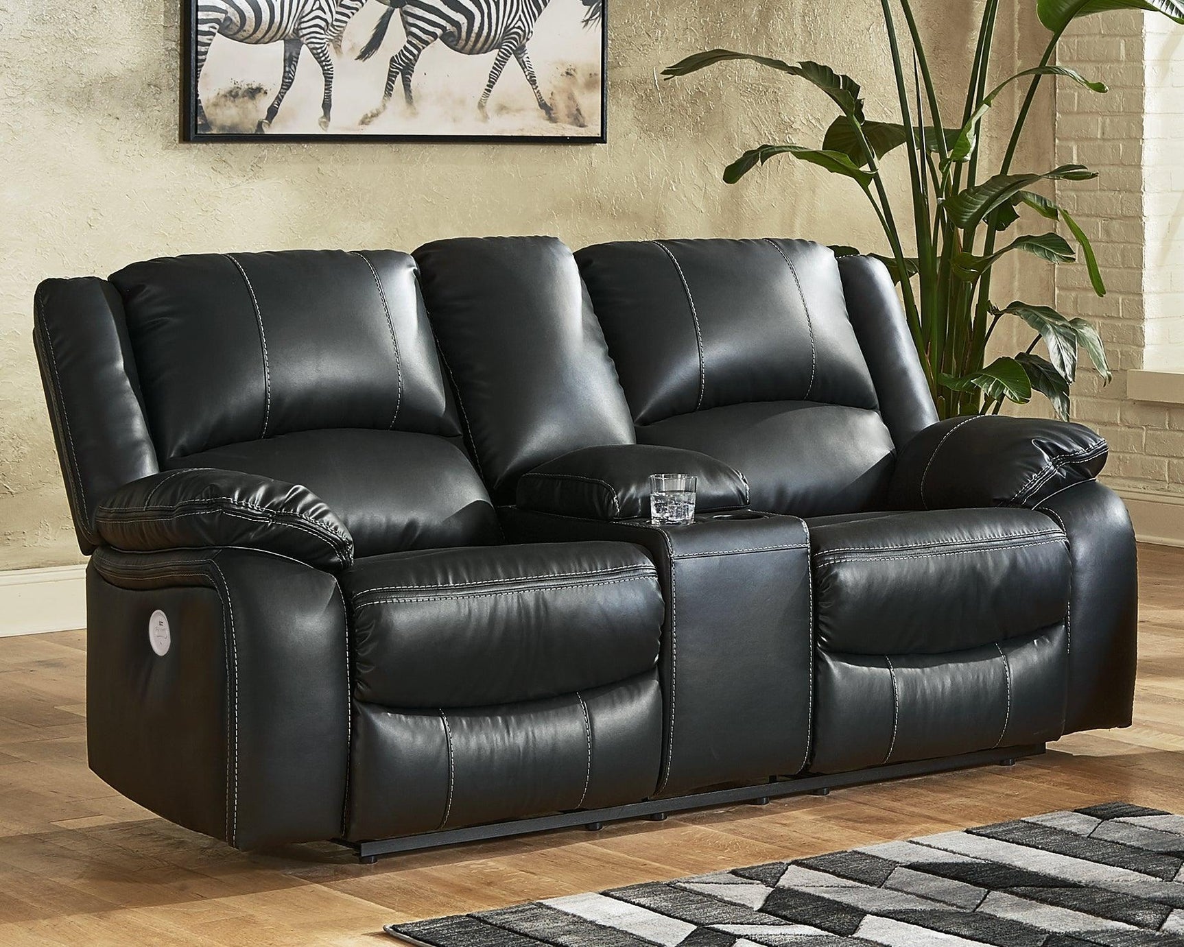 Calderwell Black Faux Leather Power Reclining Loveseat With Console - Ella Furniture