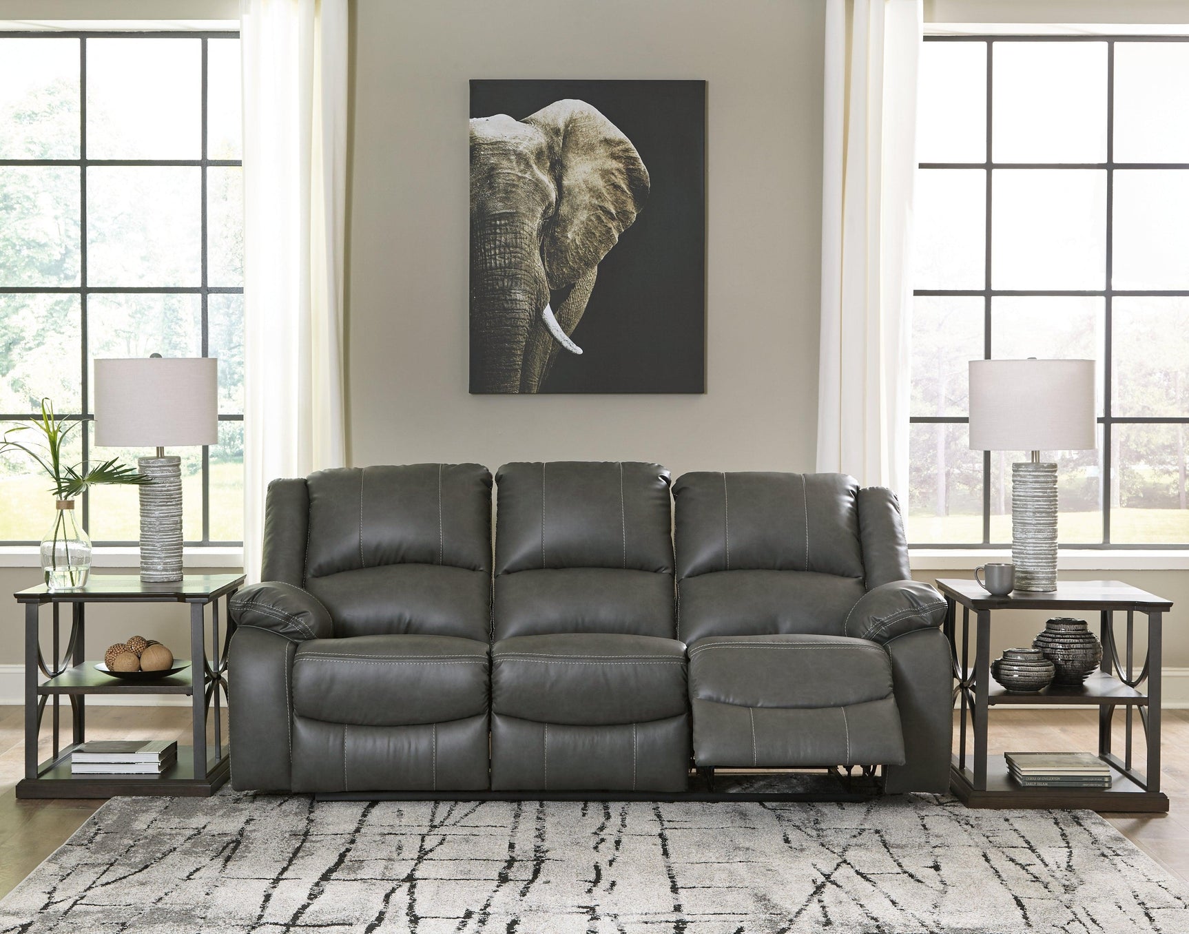 Calderwell Gray Faux Leather Reclining Sofa - Ella Furniture