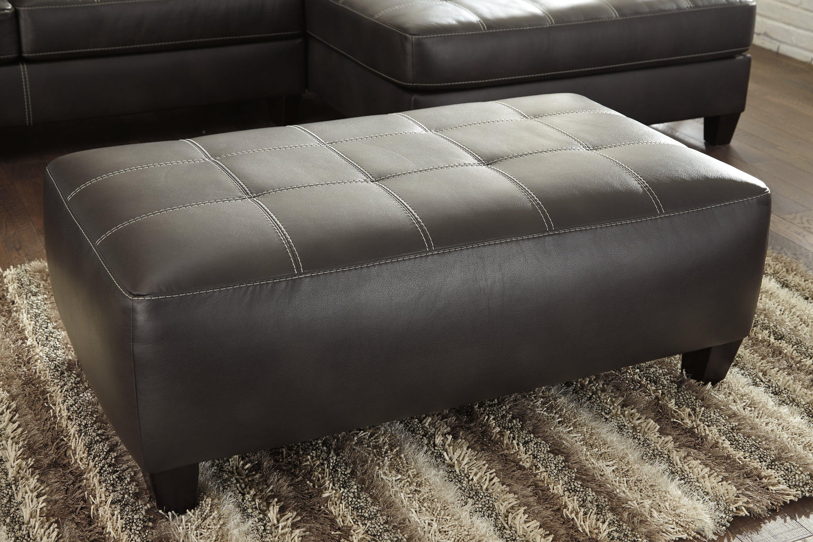 Nokomis Charcoal Faux Leather Oversized Accent Ottoman - Ella Furniture
