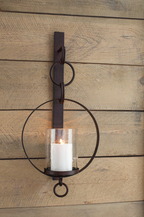Ogaleesha bronze-tone wall sconce close-up on glass shade