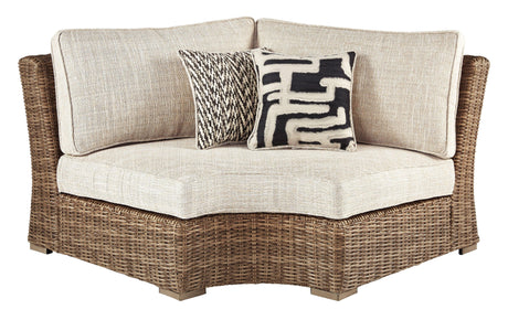 Beachcroft Beige Curved Outdoor Corner Chair head-on view showing wicker detail